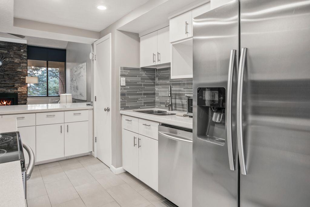 The bright and modern kitchen at Park Avenue 296 is fully stocked with stainless steel appliances and ample storage, making every meal a pleasure during your Park City stay.
