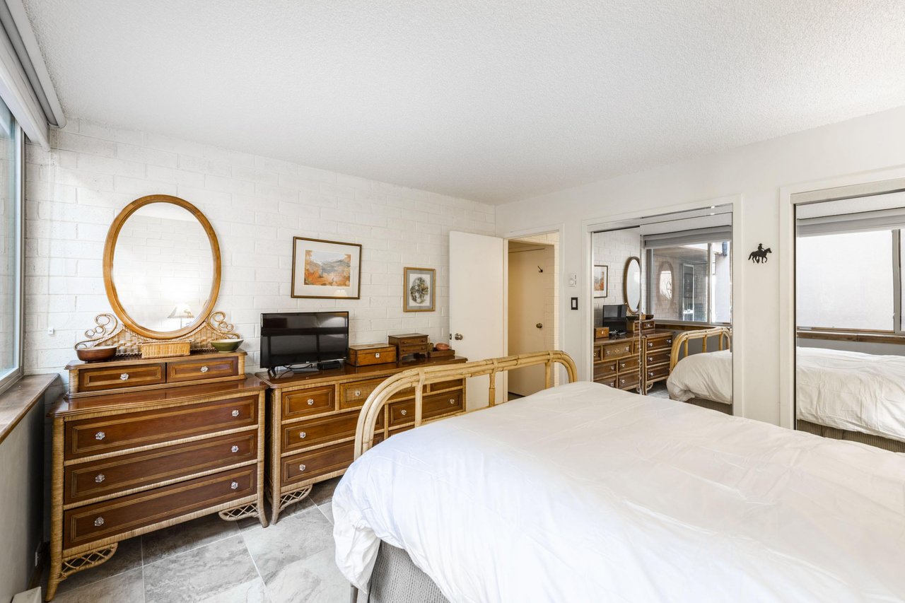 The spacious primary bedroom at Park Avenue 297 offers ample storage, classic furnishings, and a comfortable and restful atmosphere.