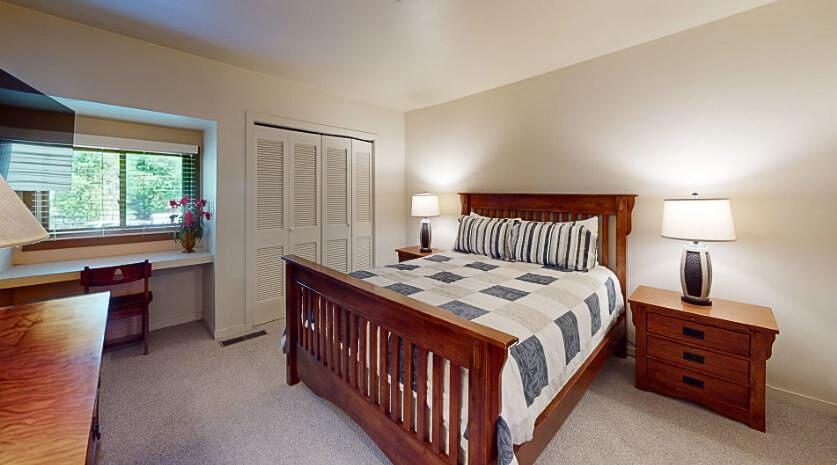This beautifully furnished bedroom with a classic wood bed frame and plush bedding is your perfect mountain retreat after a day of adventure. This Park City lodging choice is perfect for a great night