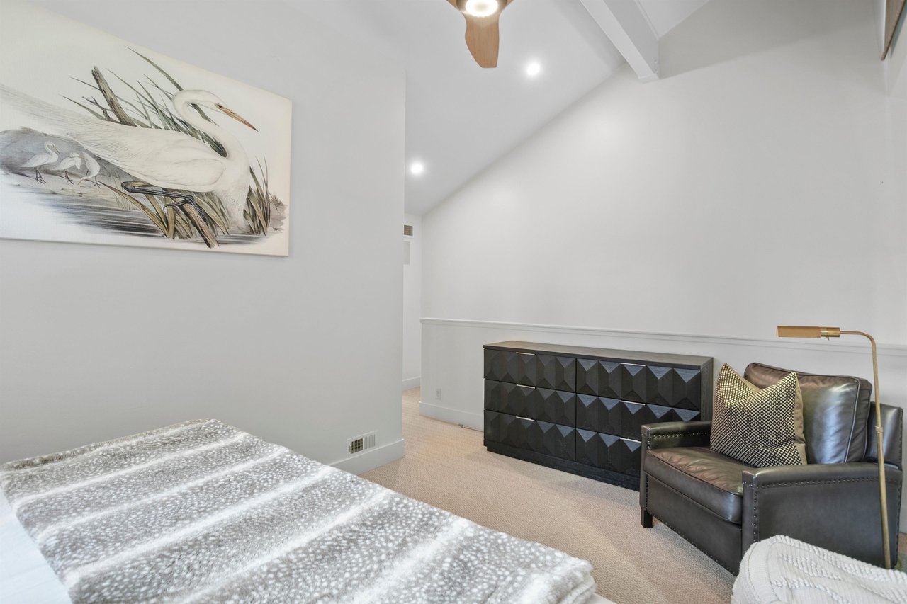 The sleek and modern loft bedroom at Three Kings 64 features soaring vaulted ceilings, leather seating, and contemporary decor that create a stylish and unique sleeping space in this exceptional Park