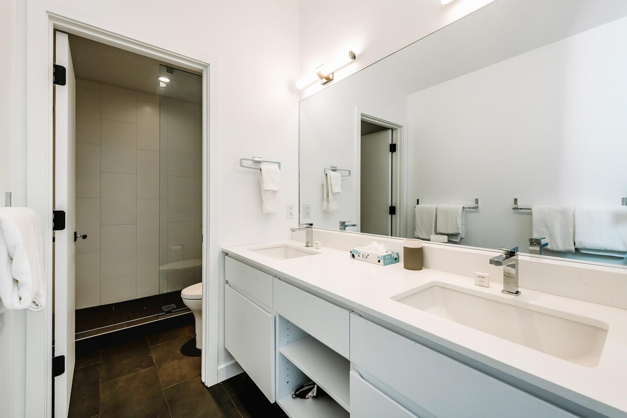 Three Kings 80 continues its modern aesthetic into the bathroom, featuring a sleek double vanity and clean, contemporary finishes.