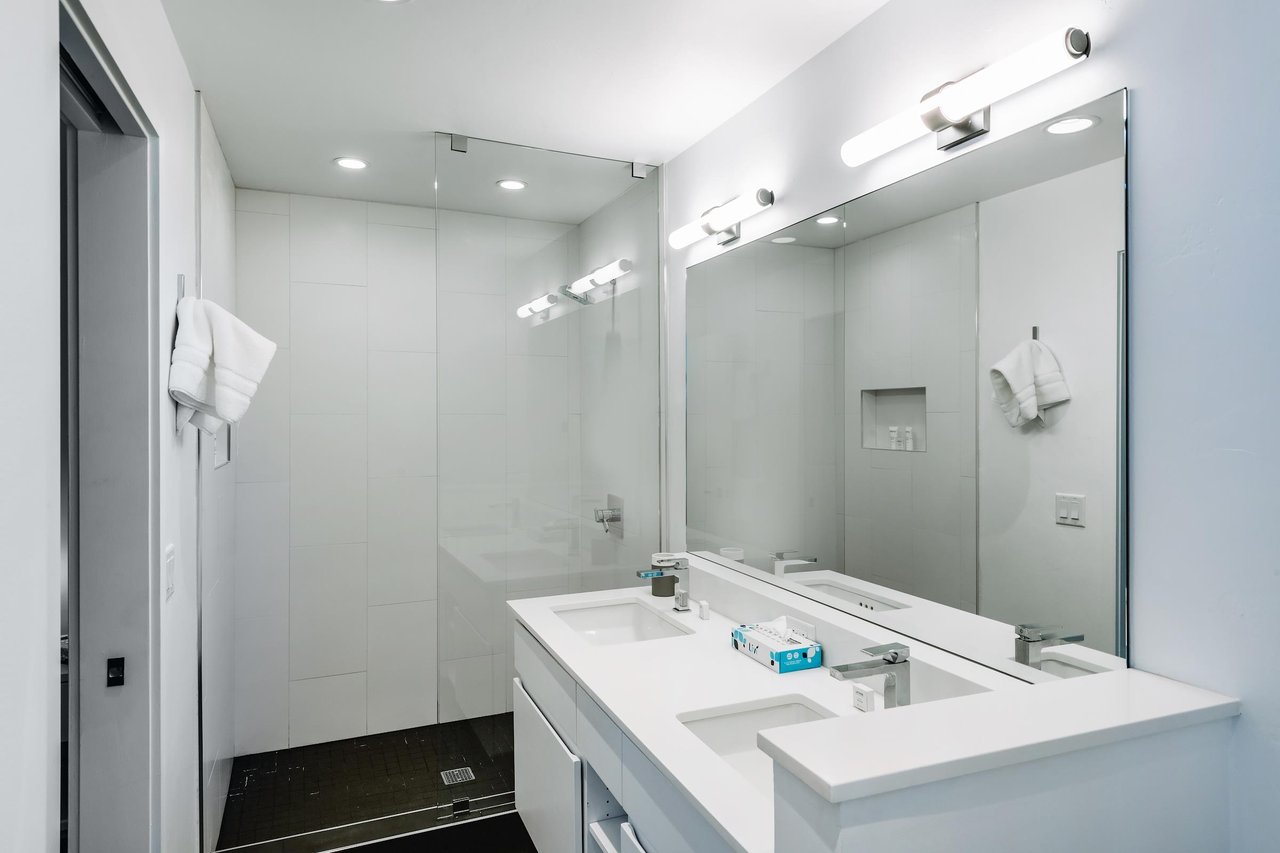 Three Kings 80 delivers a spalike experience with its immaculate allwhite bathroom featuring a double vanity and oversized walkin shower.