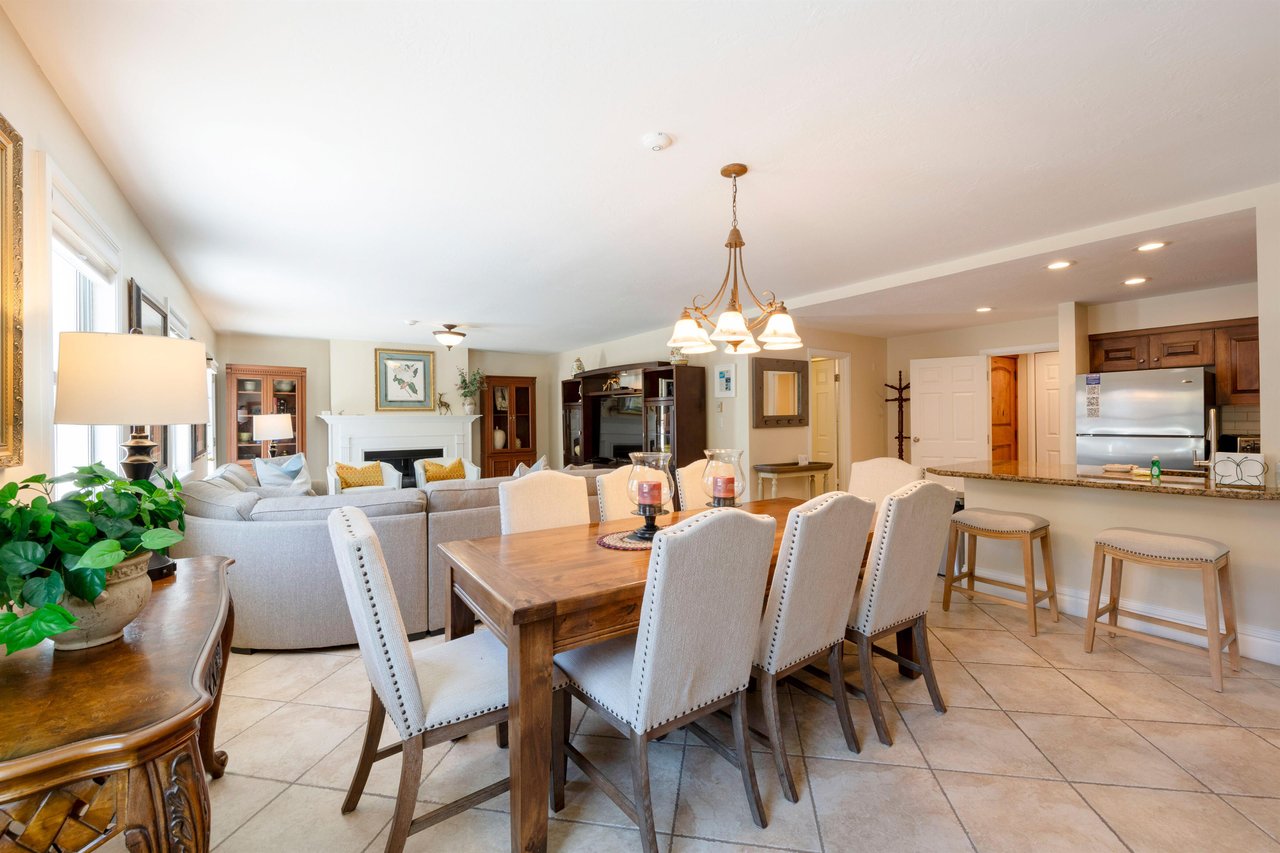 This spacious Park City condo rental features a sophisticated dining room with ample seating, warm natural light, and a welcoming atmosphere perfect for memorable meals with family and friends.