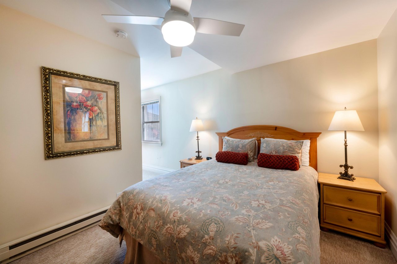 Cozy and inviting, this warm bedroom at Resort Plaza 5004 is the perfect place to recharge after a busy day.