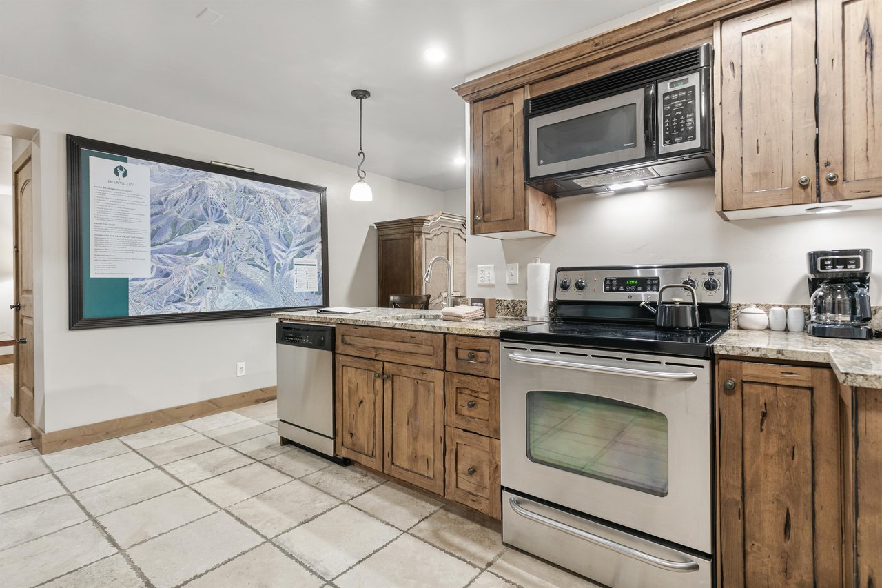 Your fully equipped kitchen features granite counters, stainless appliances, and rustic wood cabinetry—everything you need to prepare delicious meals in comfort.