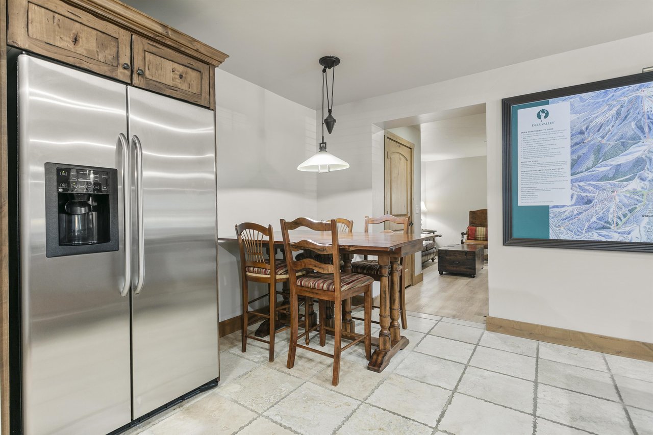 Gather around this rustic dining table for meals and conversation, with a fully equipped kitchen at your fingertips and warm, inviting spaces flowing seamlessly into the living area.
