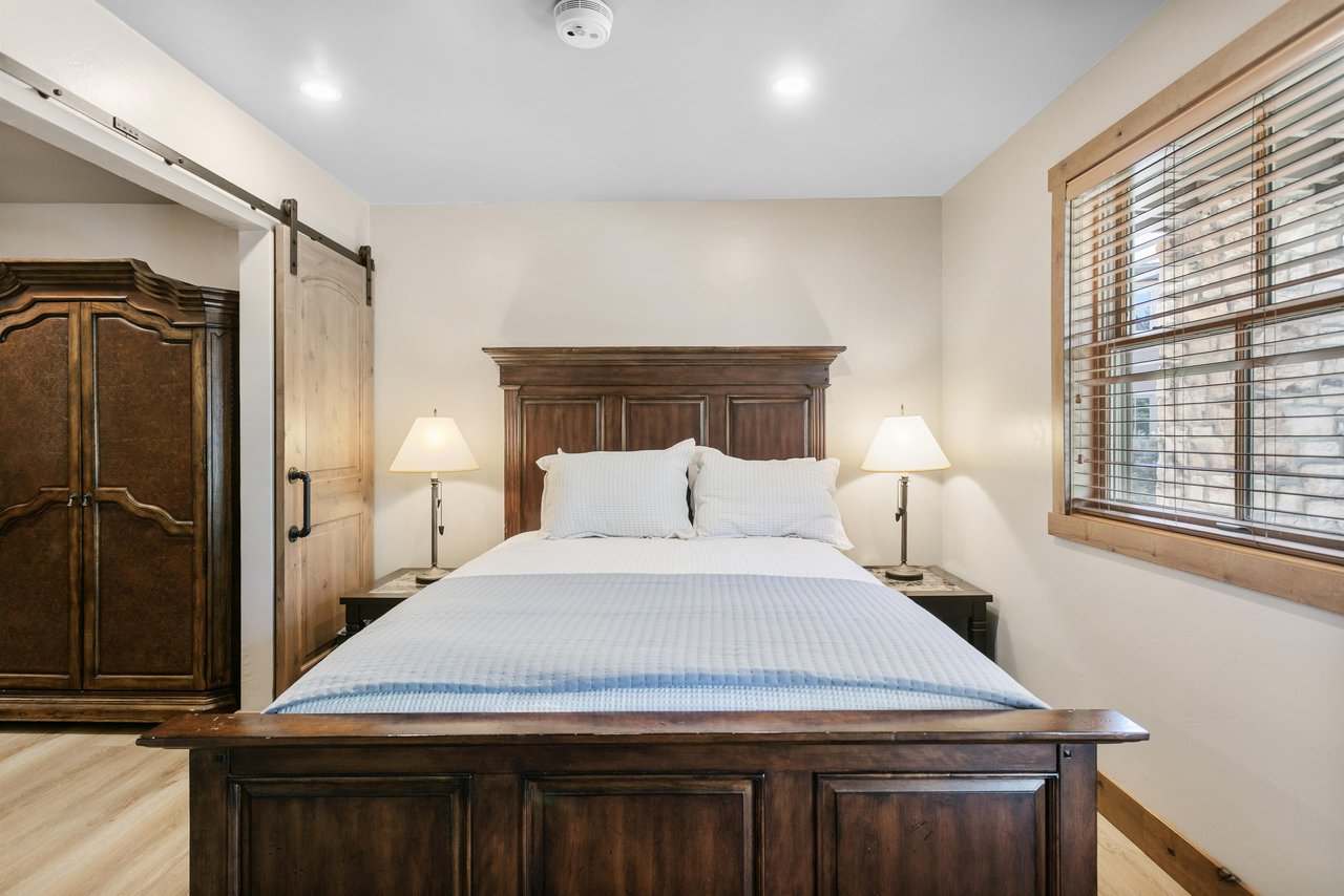Rich wood furnishings and warm lighting give this bedroom a relaxed, comfortable feel.