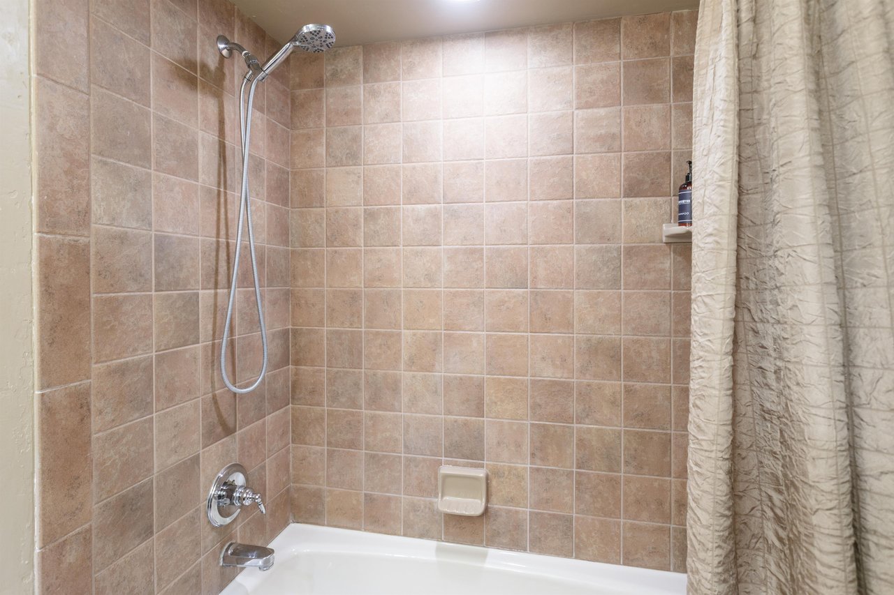 The private bathroom includes a tubshower combo with a rainfall showerhead — a nice way to unwind.