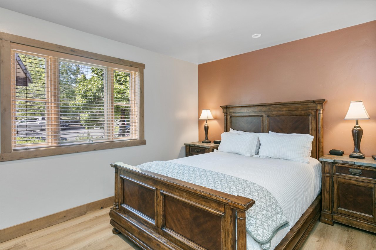 Clean white linens and warm wood tones keep this bedroom feeling restful and peaceful.