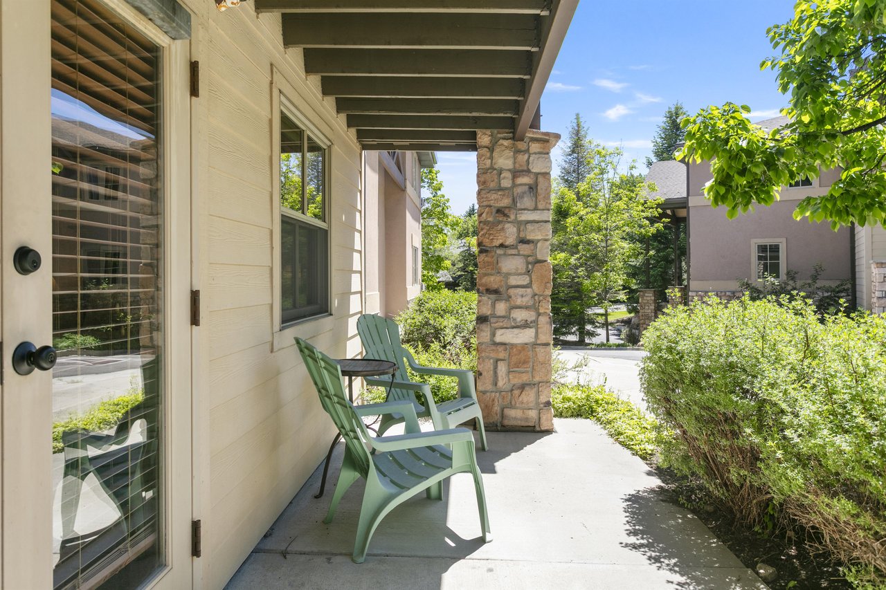 Step outside to a covered patio with seating and stone accents — a quiet spot to decompress after time on the slopes.