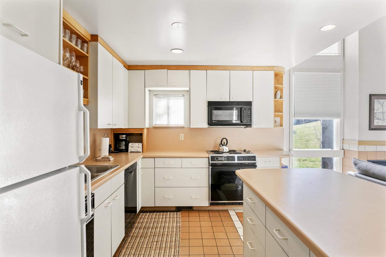 The bright, fully equipped kitchen has everything you need to prepare meals during your stay, with ample counter space and plenty of natural light.
