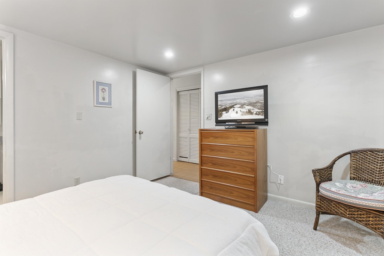 This inviting master bedroom features dresser storage and a TV — a comfortable home base for your Park City vacation.