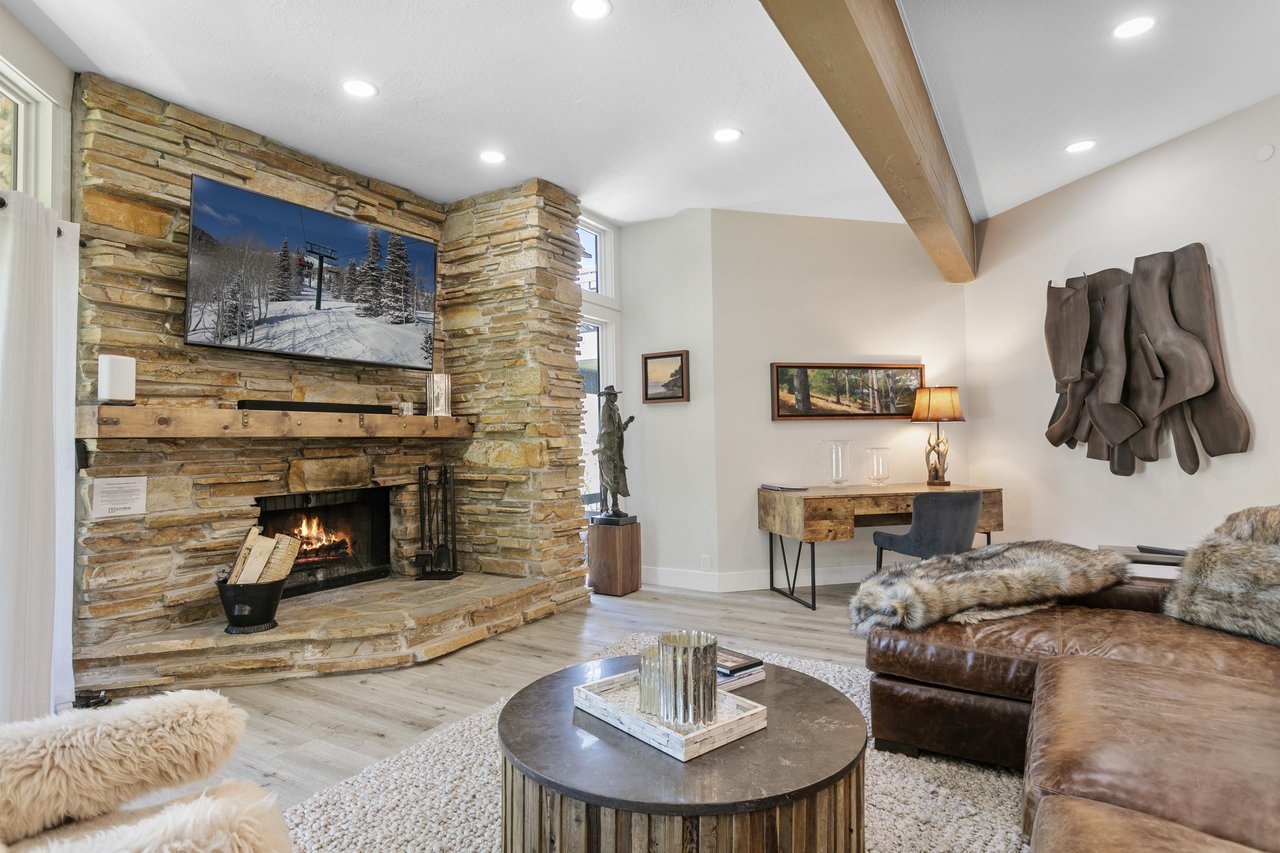 Curl up by the crackling woodburning fireplace and catch your favorite shows on the wallmounted smart TV at Powder Run C13 — a premier Park City lodging destination steps from Deer Valley Resort, w