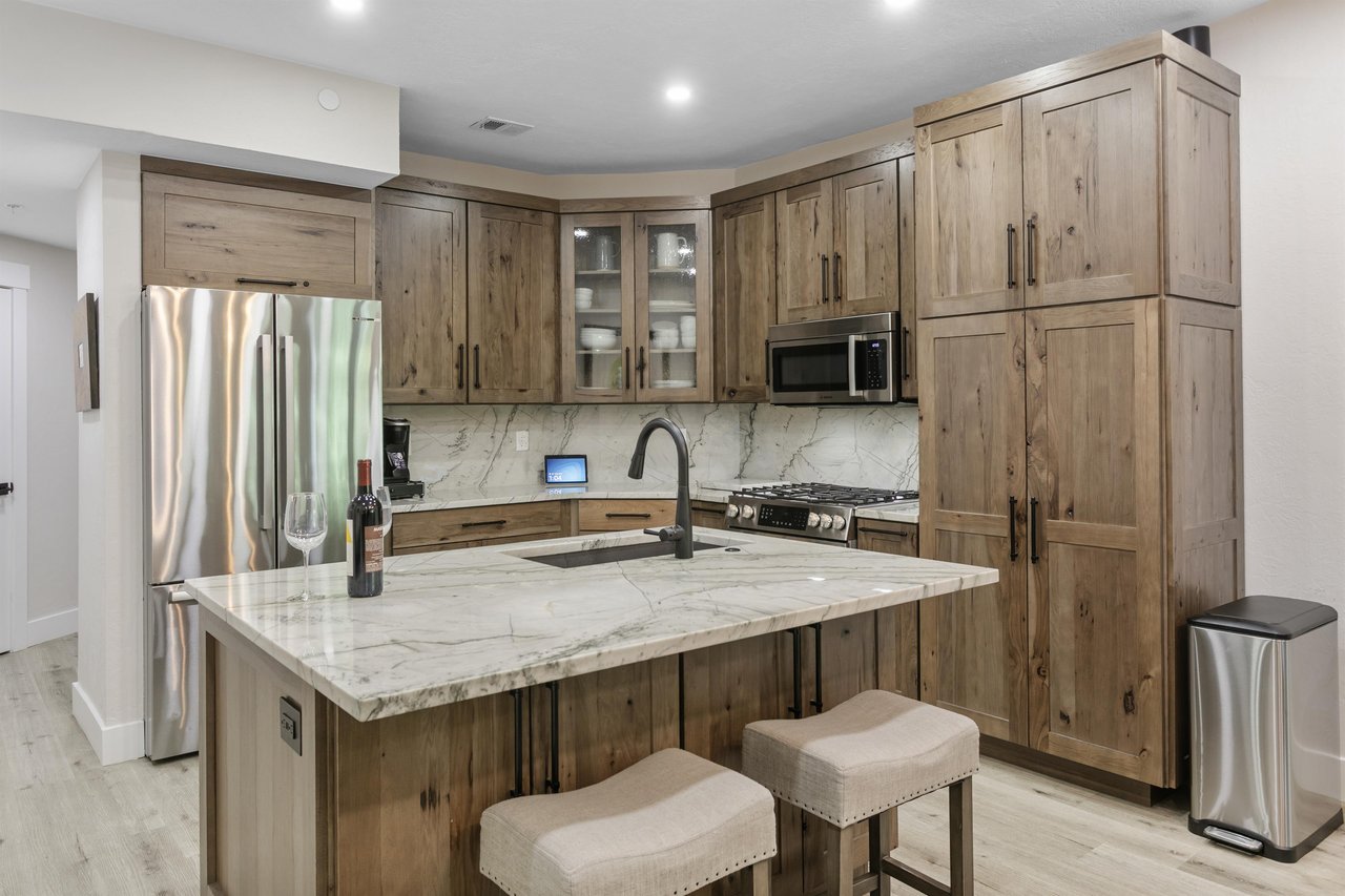 Pour a glass and settle in — the gorgeous kitchen at Powder Run C13 features stunning quartz countertops, custom wood cabinetry, and premium stainless steel appliances.