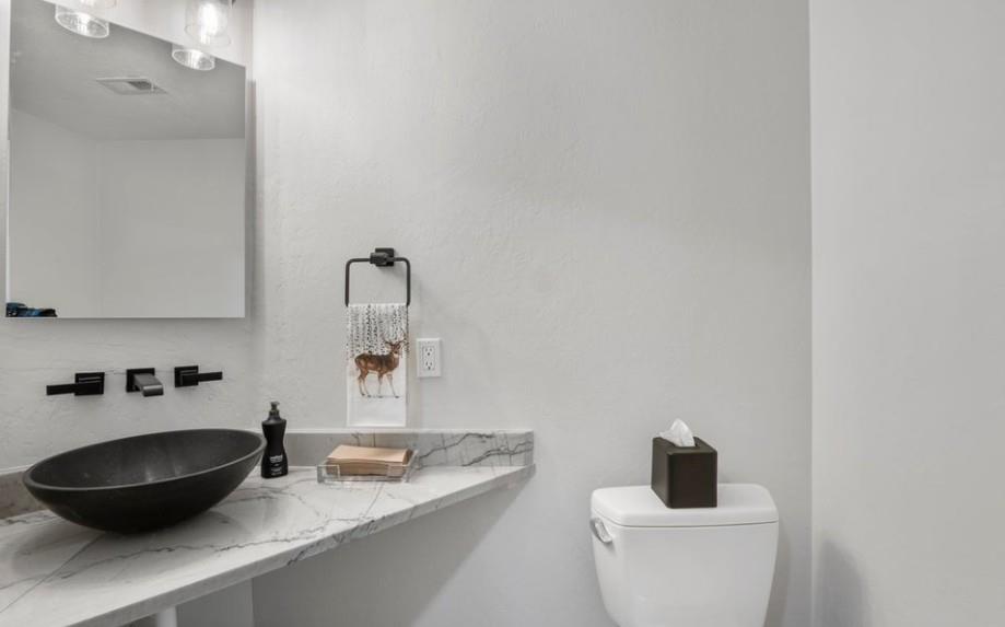 Sleek and stylish, the modern half bathroom at Powder Run C13 features a chic vessel sink and marble countertop — a polished finishing touch in this beautifully updated Deer Valley vacation rental.