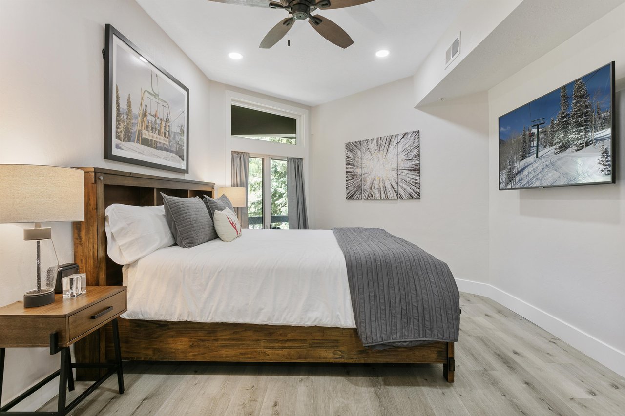 Modern, clean, and thoughtfully designed, this comfortable bedroom at Powder Run C13 offers a wallmounted smart TV and flexible sleeping arrangements.
