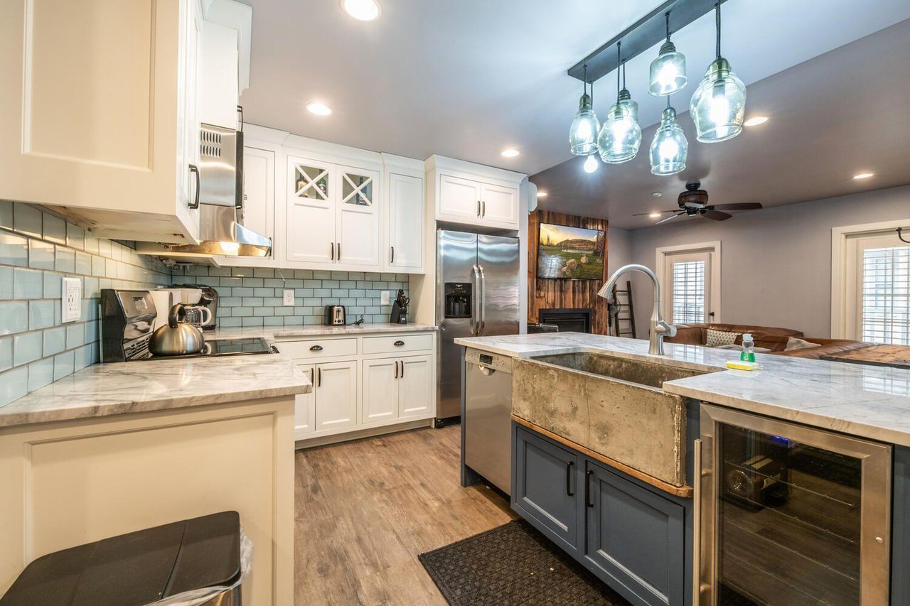 Resort Plaza 5000 features a beautifully renovated kitchen with a dramatic dark island, crisp white cabinetry, and stylish pendant lighting — a chefready Park City vacation rental setup perfect for g