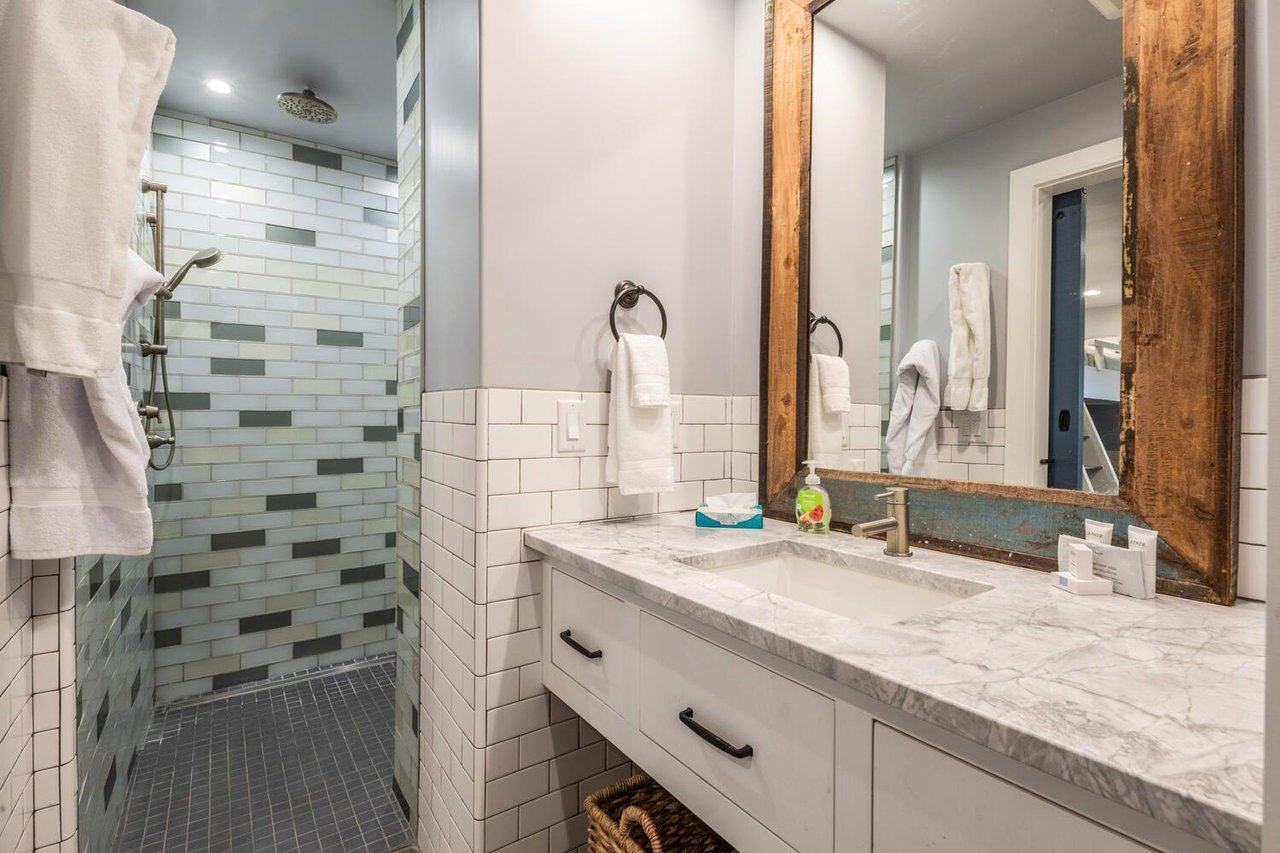 Every guest is well taken care of at Resort Plaza 5000 — this beautifully finished bathroom features a modern vanity, stylish tile accents, and all the essentials that define a premier Park City lodgi