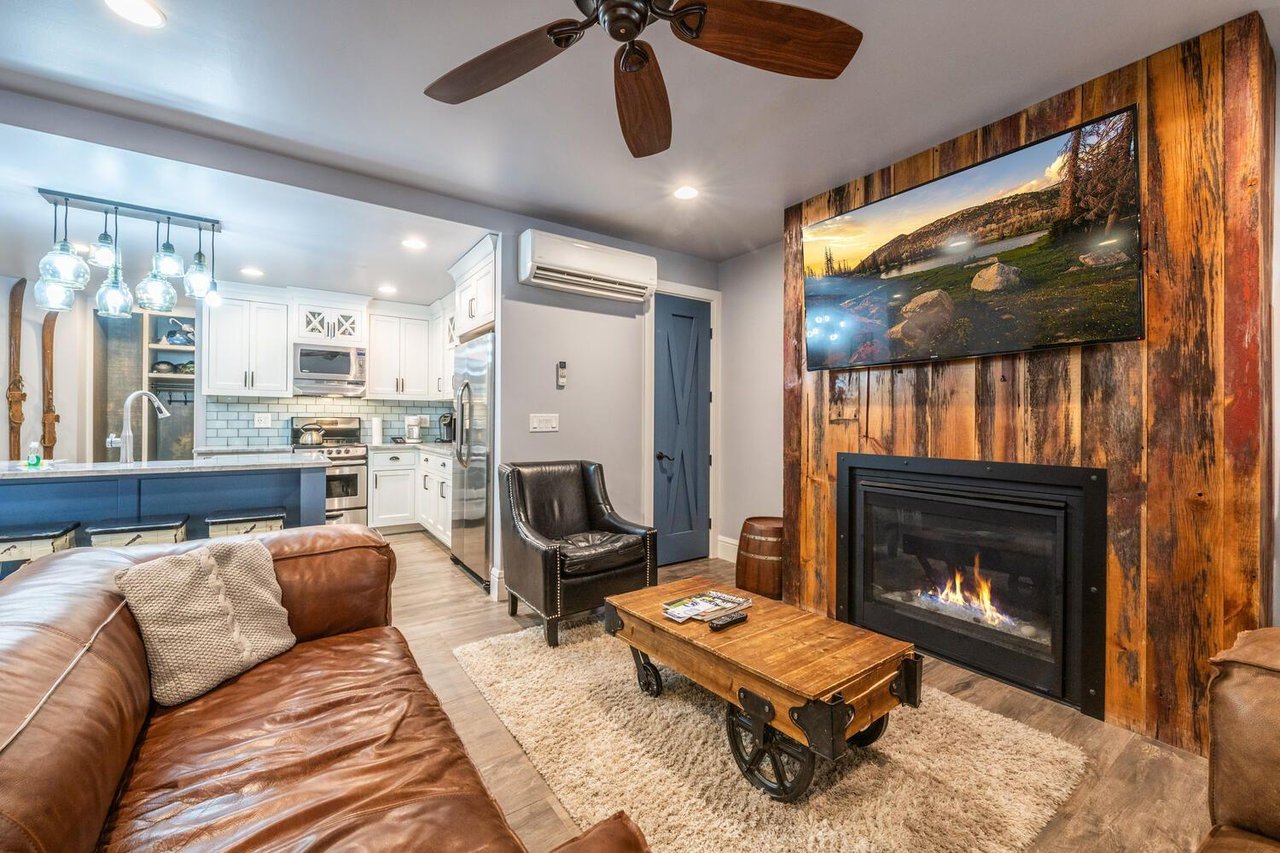 Resort Plaza 5000 welcomes you with a freshly renovated living space featuring a modern gas fireplace, warm hardwoodstyle flooring, and leather sofas — a stylish and inviting Park City vacation renta