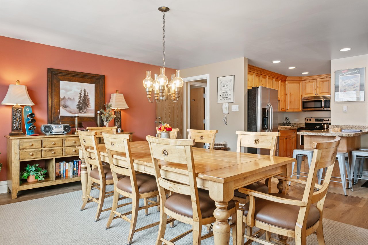 Resort Plaza 5064 is designed for togetherness, featuring a generously sized dining area with elegant chandelier lighting and seamless access to the fully equipped kitchen, making this Park City condo
