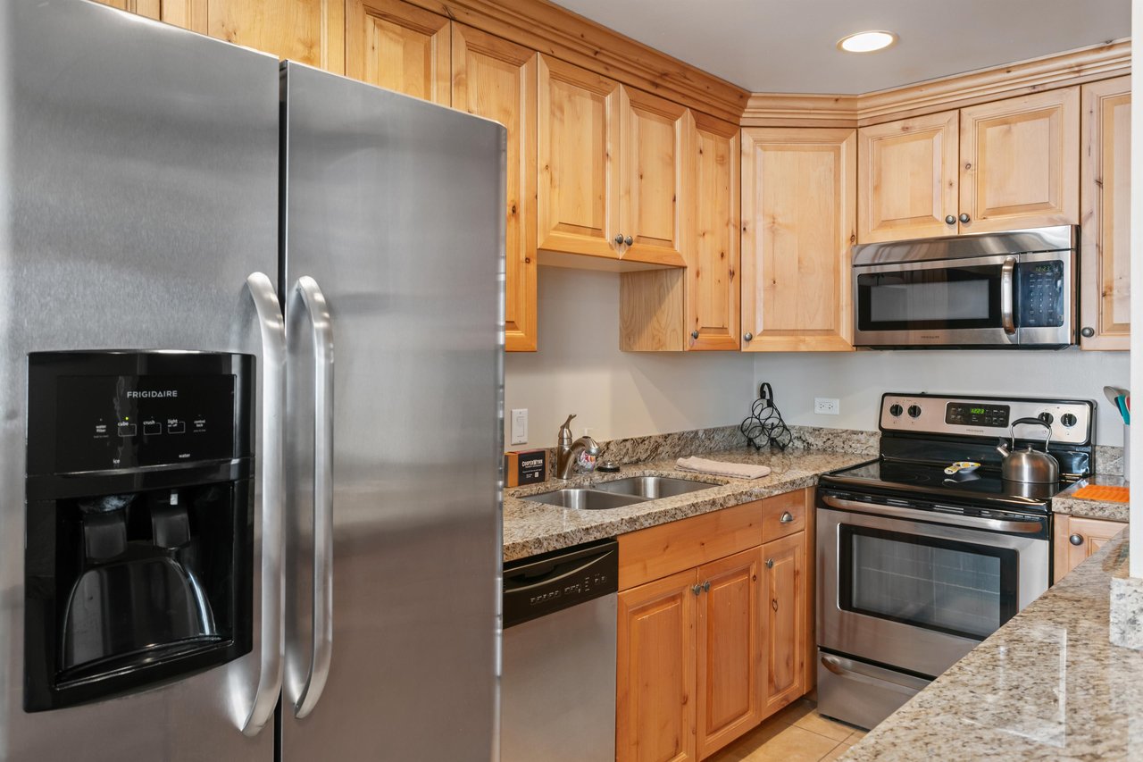A full kitchen with stainless steel appliances and granite counters, ready for morning coffee or a homecooked dinner.