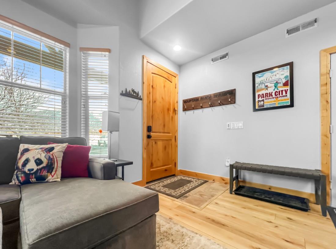 Step inside to a bright, welcoming entryway where natural light fills the space and warm wood floors greet you. Kick off your boots, hang your gear, and settle in—your mountain escape starts here.