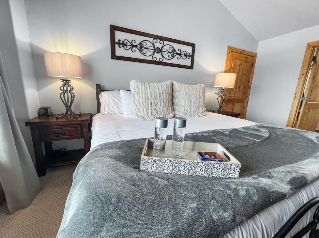 Sink into plush linens and soft textured pillows in your restful bedroom retreat. Warm lamplight and thoughtful touches create a cozy, welcoming space where youll drift off easily after each days ad
