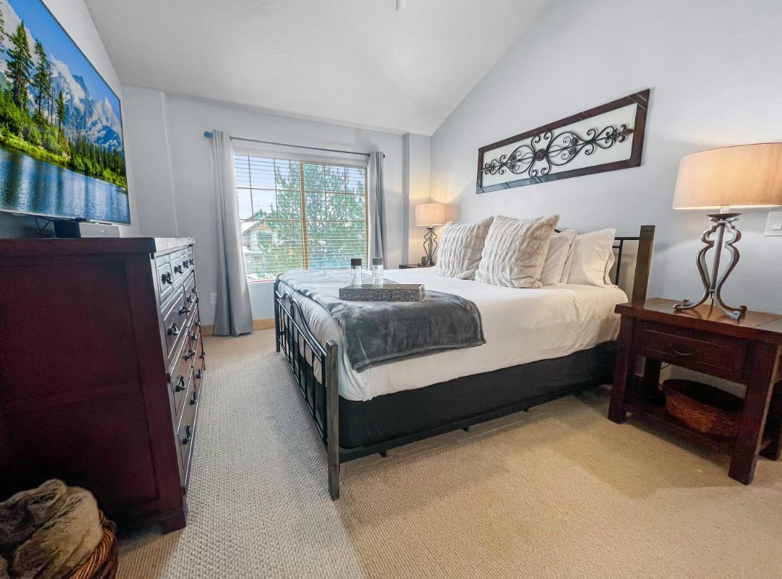 Your peaceful retreat awaits with a plush bed, soft linens, and natural light streaming through the window. Elegant touches and thoughtful decor create a cozy sanctuary where you can truly unwind.