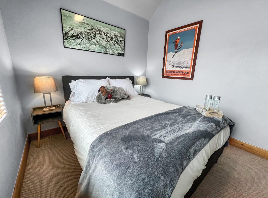 Sink into crisp linens and soft textures in your cozy mountain retreat, where vintage ski posters and alpine charm set the tone for peaceful evenings.