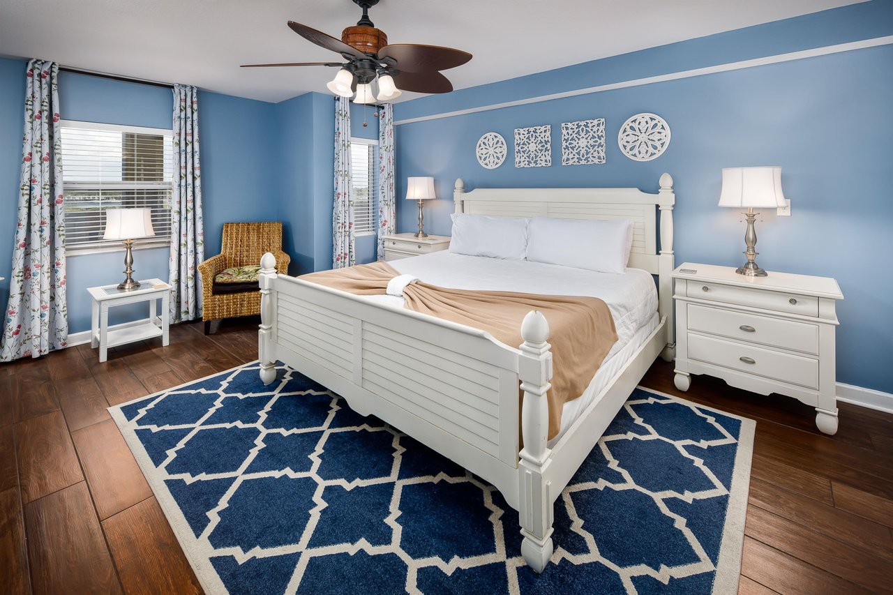 Beachy Bliss Bright blue walls complement stylish decor in this inviting bedroom retreat