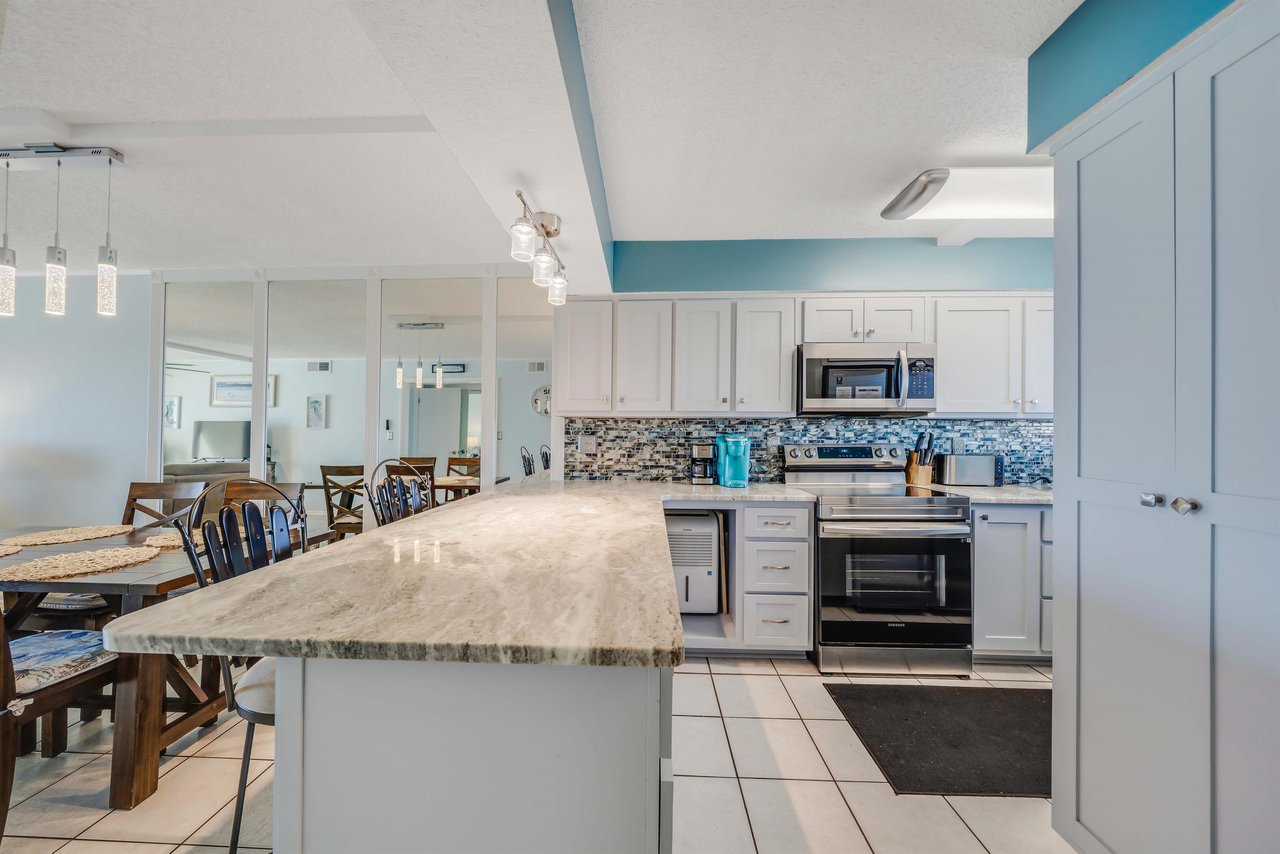 The updated, fully equipped kitchen features quartz countertops, stainlesssteel appliances, and has everything you need to prepare meals for family  friends.