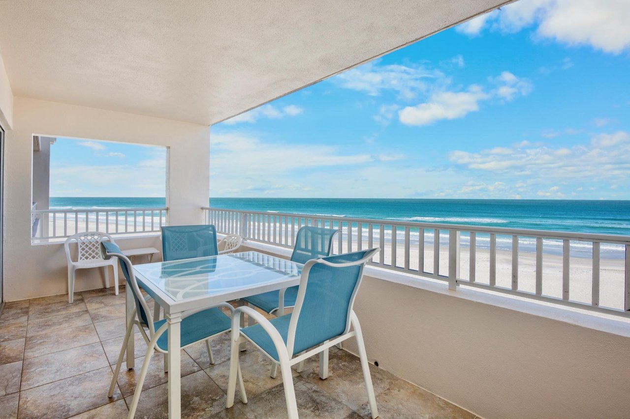 Private oceanfront balcony with dining
