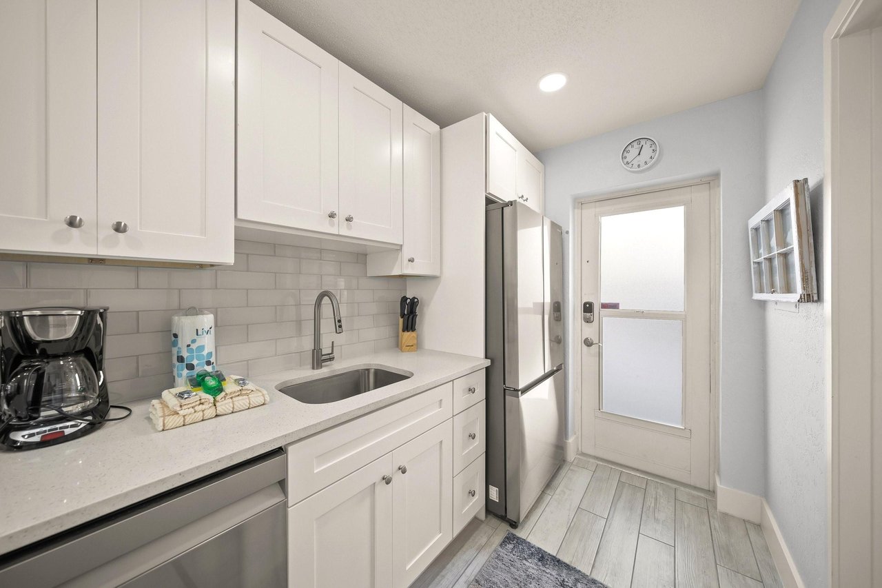 Your bright, modern kitchen features crisp white cabinets, stainless appliances, and everything you need for homecooked meals.