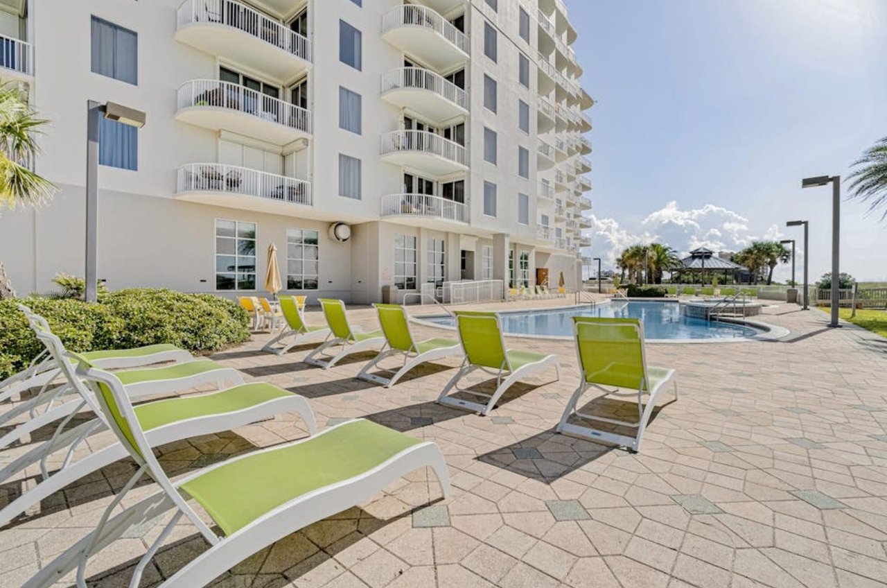Lounge chairs on the Gulffront pool deck by the outdoor swimming pool at Spanish Key