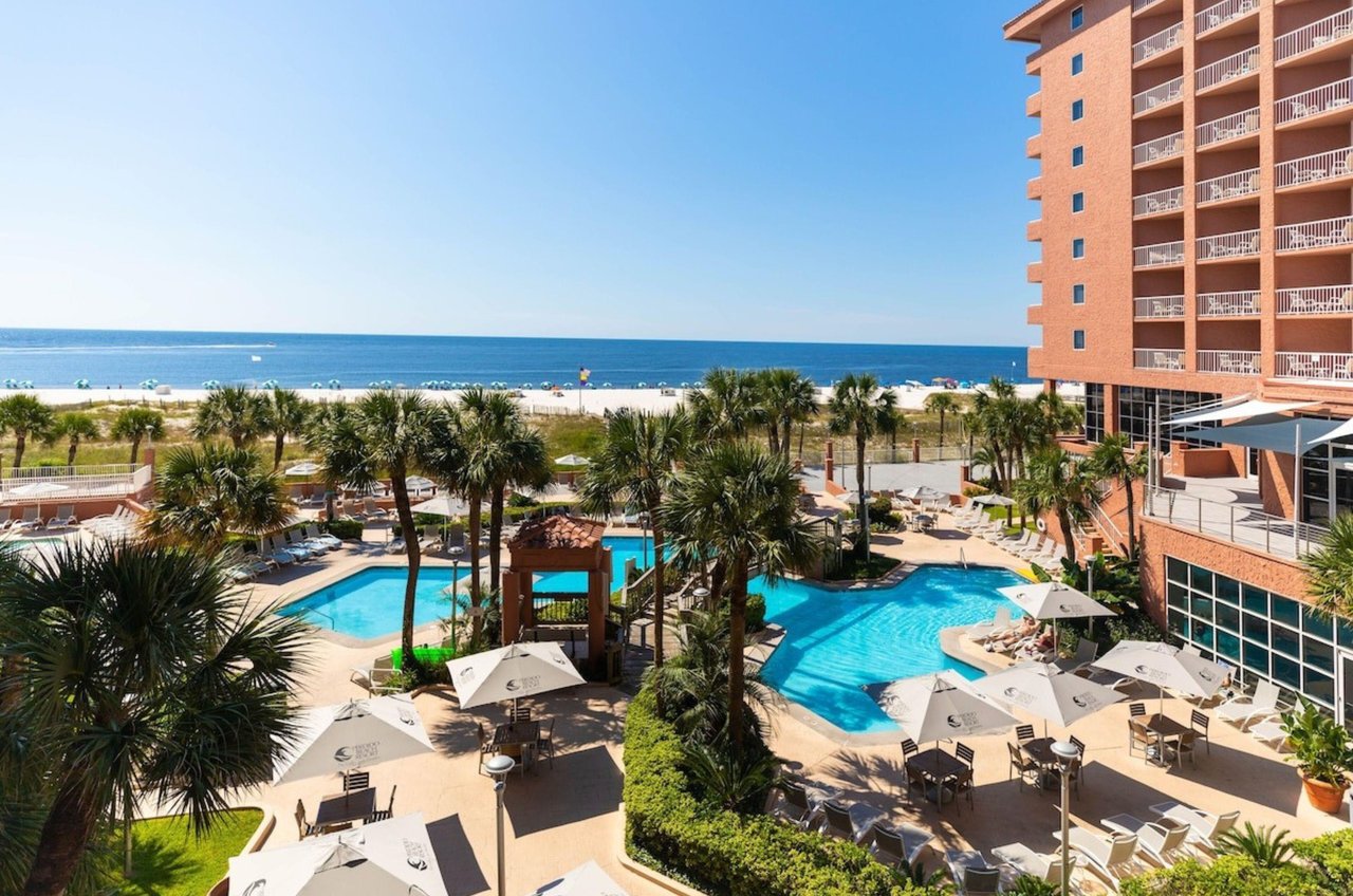 The tropical pool and pool deck next to the beach at Perdido Beach Resort in Orange Beach Alabama