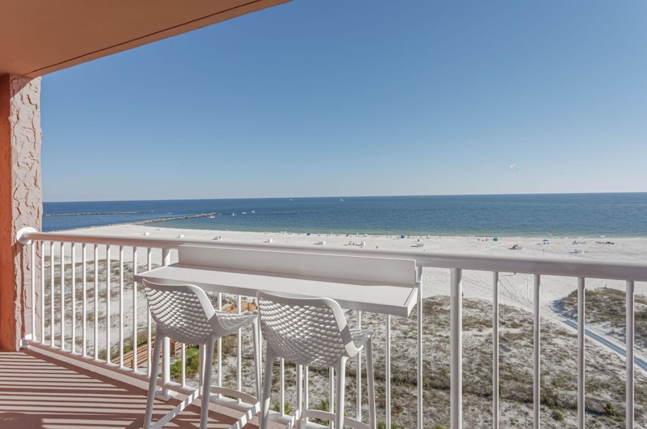 A private balcony with a chair overlooking the Gulf in Orange Beach Alabama