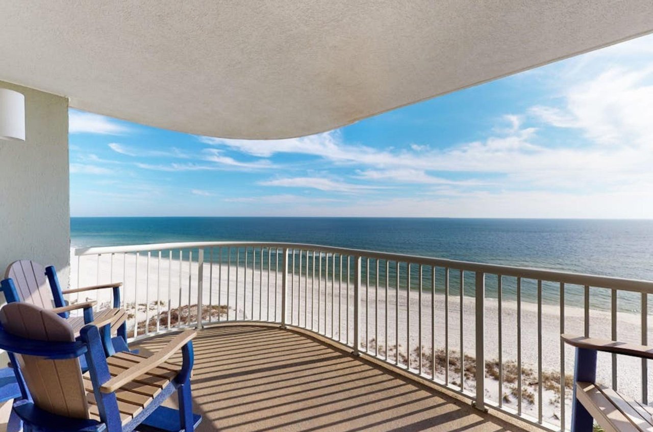 A balcony with chairs overlooking the Gulf at Tradewinds in Orange Beach Alabama