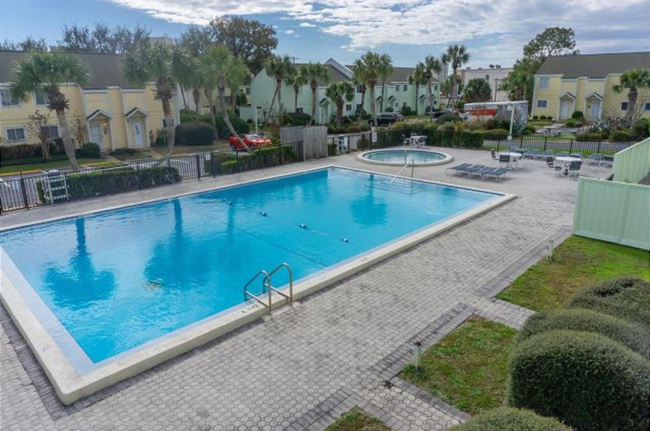A large community pool and kiddle pool that share a sun deck