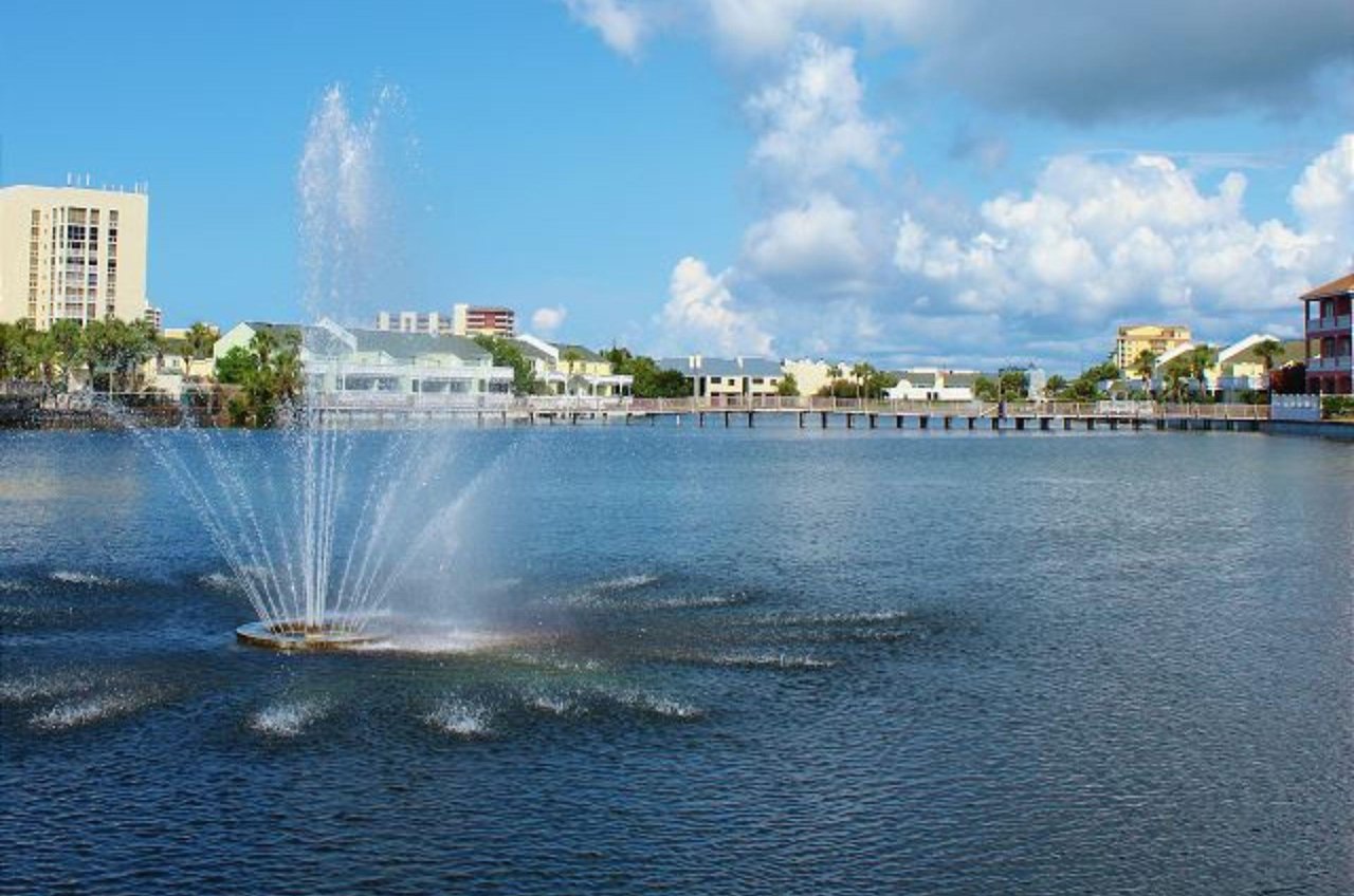 A lake with a fountain in Southbay by the Gulf in Destin