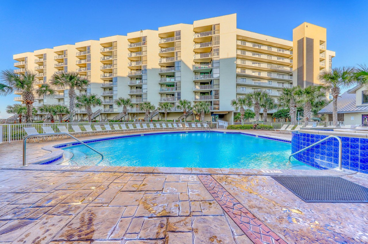 Balconies look out over the community pool and sundeck