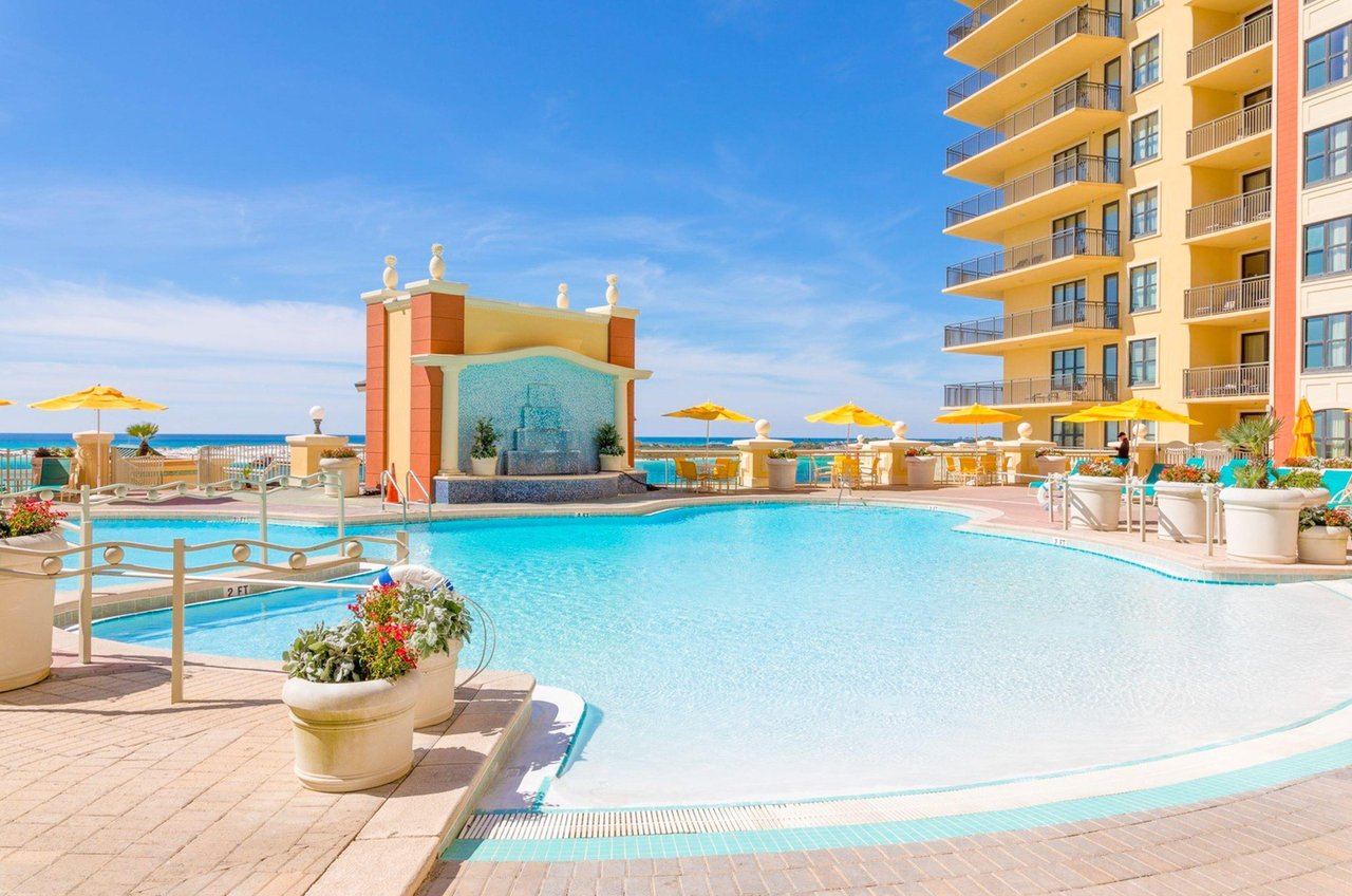 Emerald Grandes swimming pool sparkles under a blue bird sky.