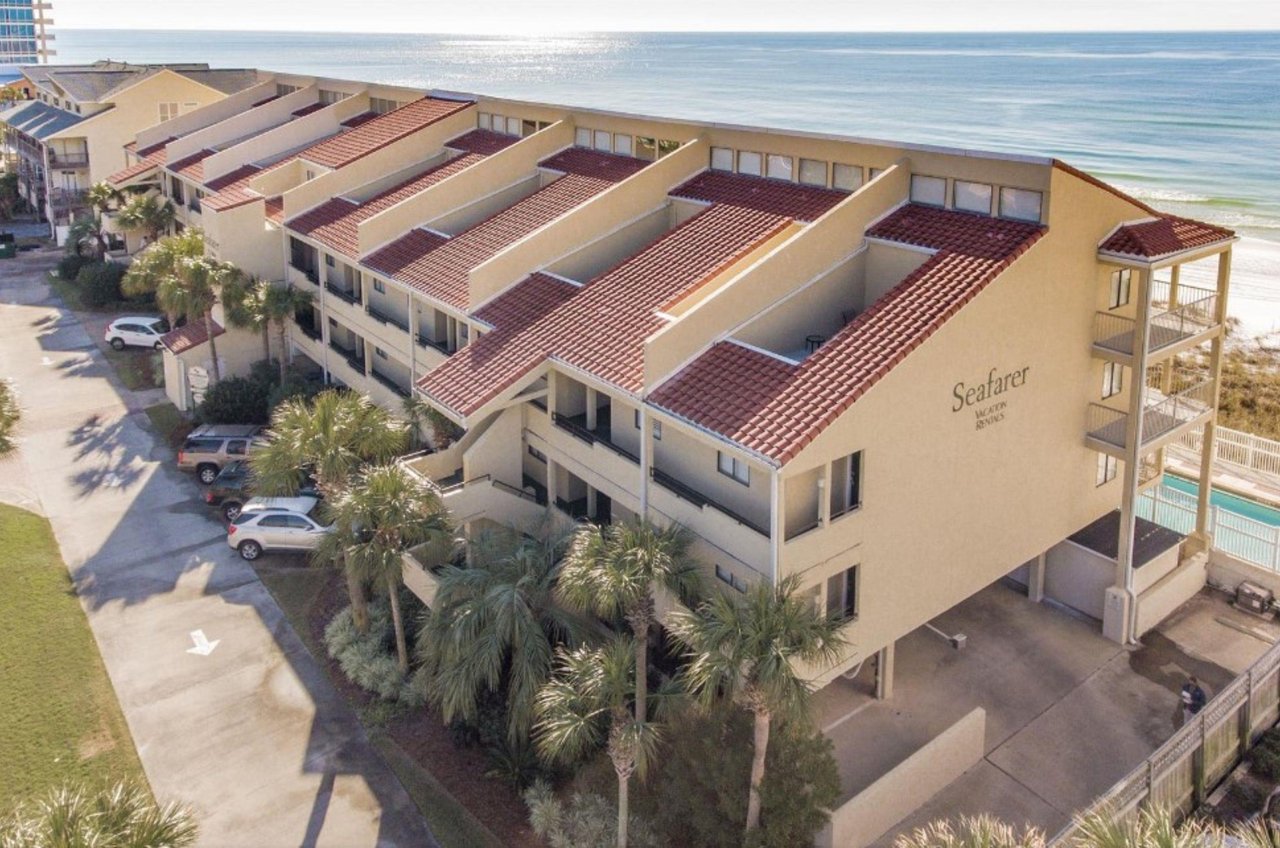 The threestory complex with the Gulf in the background.