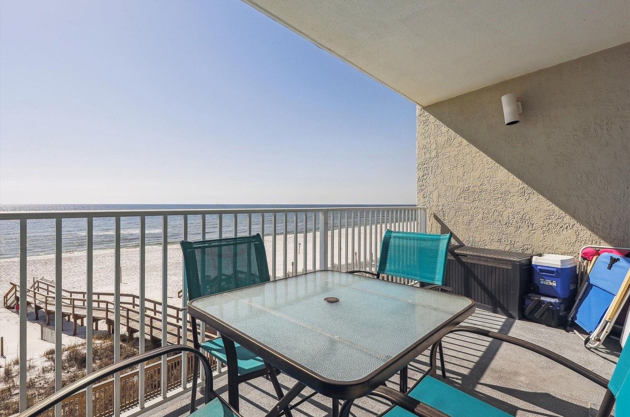 A private balcony at Perdido Skye with a table and chairs overlooking the Gulf of Mexico