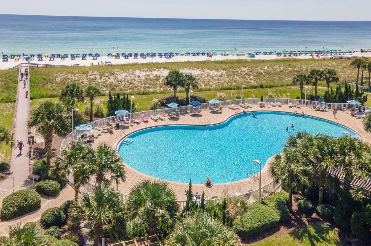 The beachfront outdoor pool and boardwalk next to Beach Colony Resort Navarre