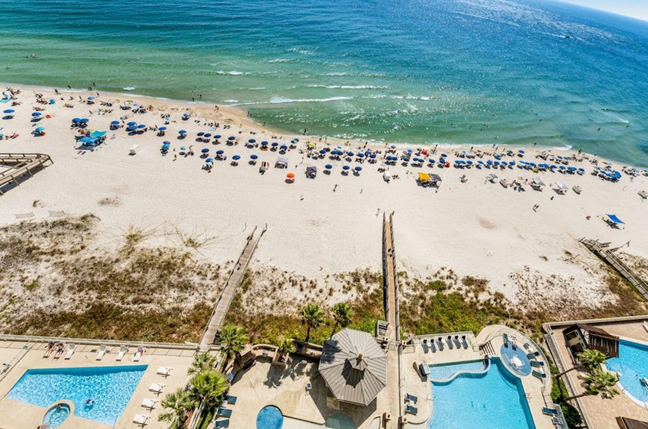 Aerial view of the pool deck and boardwalk leading to the beach at Escapes to the Shores