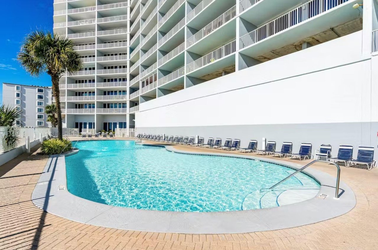 Outdoor swimming pool and deck next to Lighthouse Condominiums