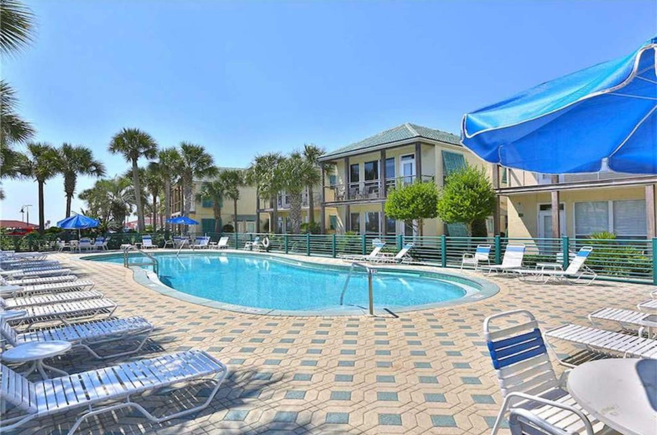 The community swimming pool and surrounding deck offer a combination of sunshine and shade.
