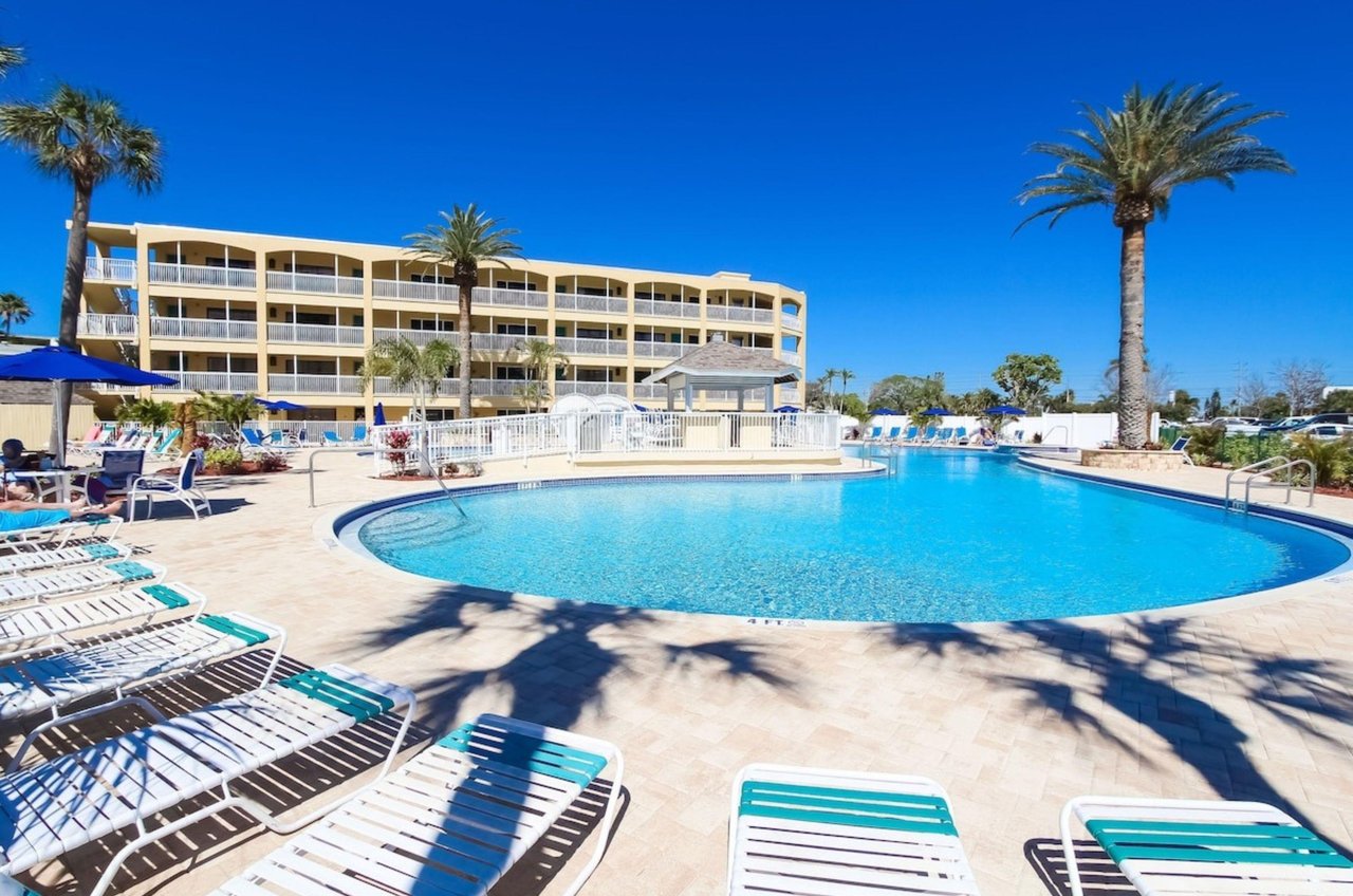 The large outdoor pool and lounge chairs in front of Coral Reef Beach Resort