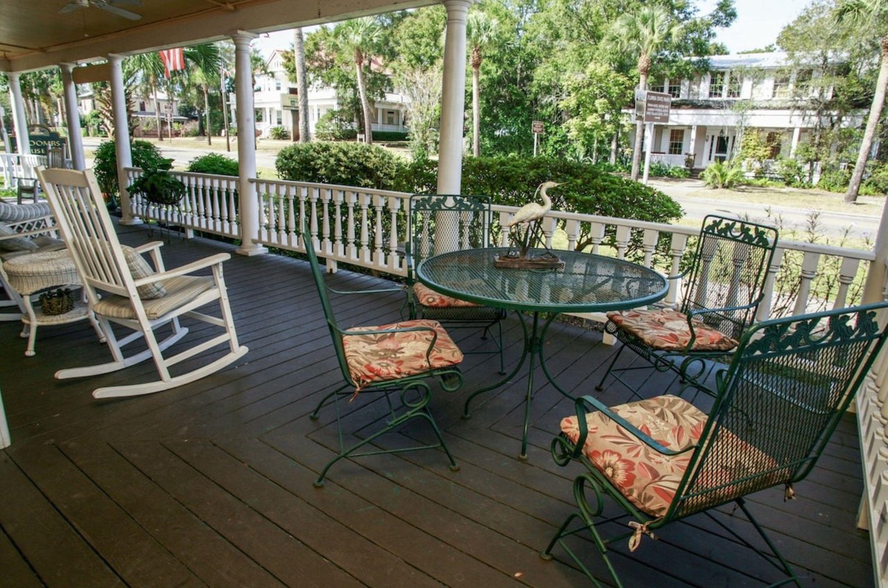 The rocking chairs and tables on the relaxing porch