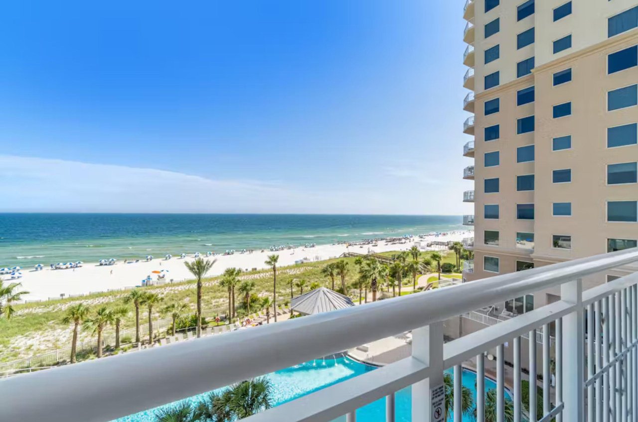 View of the outdoor pool and Gulf of Mexico from a private balcony